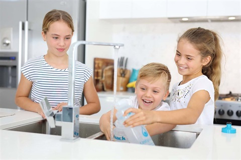 Children filling water bottles at kitchen sink (1).jpg